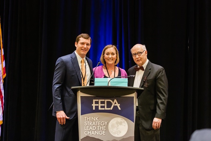 Woman accepts award from FEDA guys