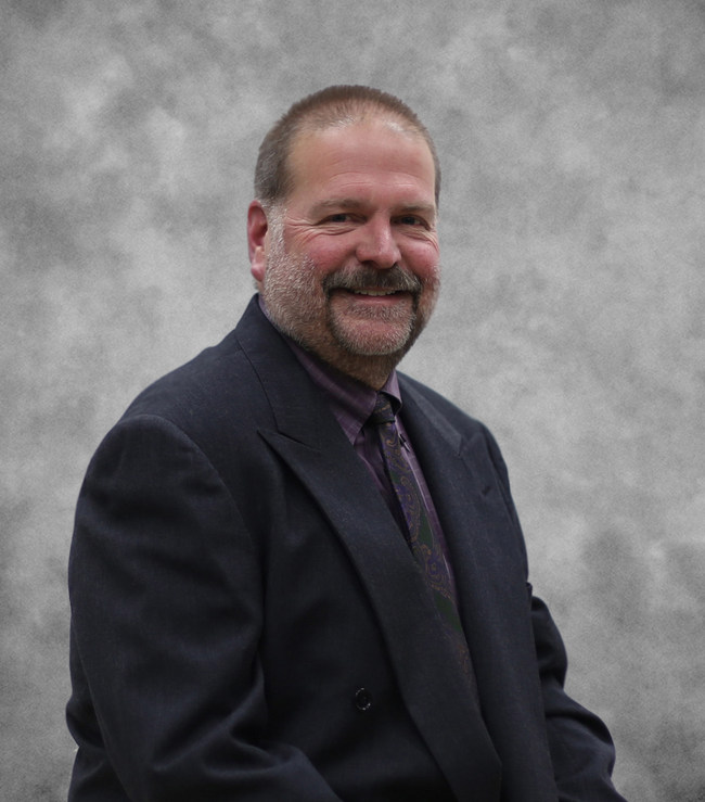 Bearded man in suit, posing