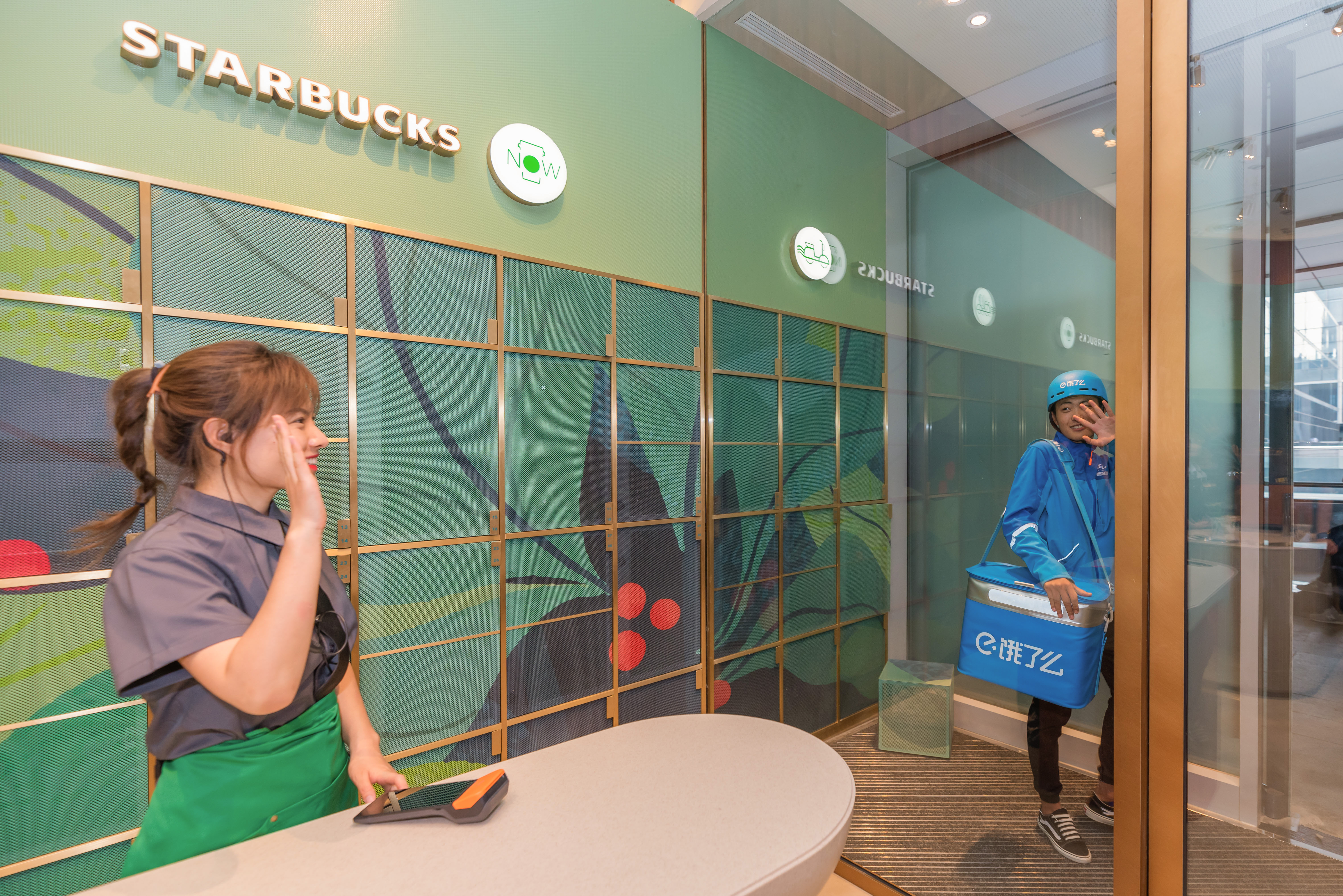 Starbucks barista waving goodbye to delivery girl