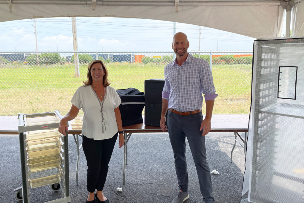 Cheryl Hodges and Nick Mirkovich train on Cambro food pan trolleys. Courtesy of Mirk Group.